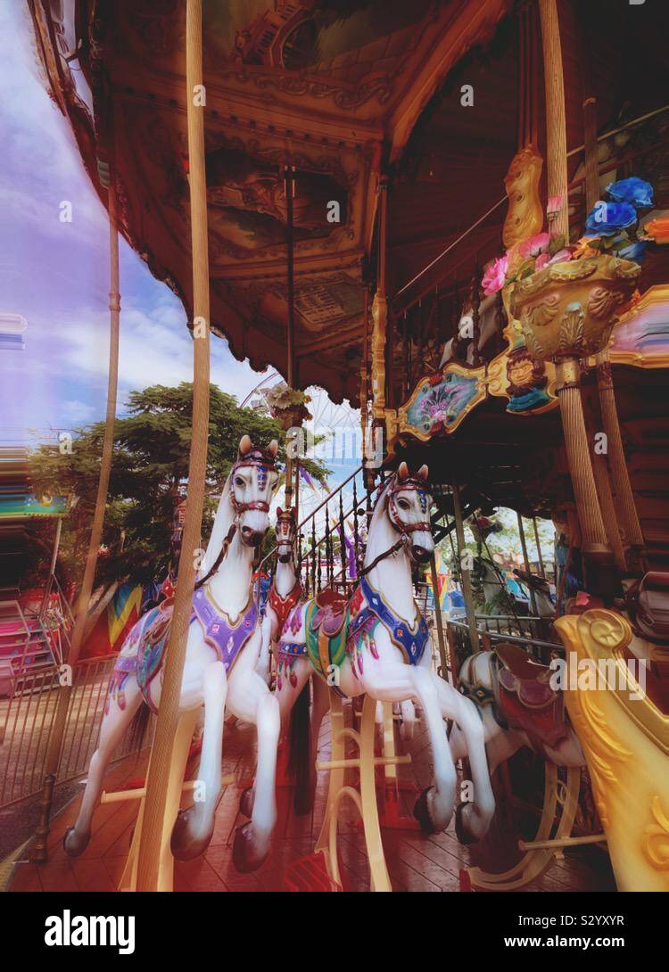Merry-go-round horses are an enticing amusement park ride at the Feria Yucatán Xmatkuil. Stock Photo