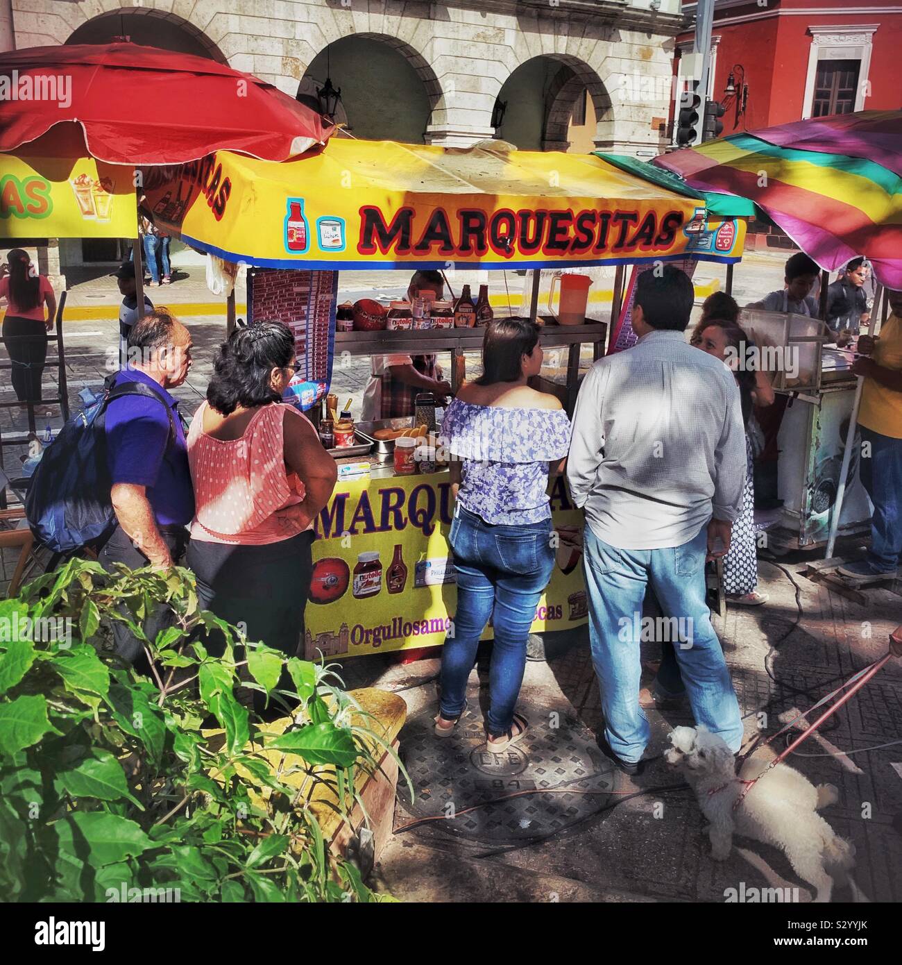 People are lined up to buy Marquesitas from a street vendor in Mérida, México. Stock Photo