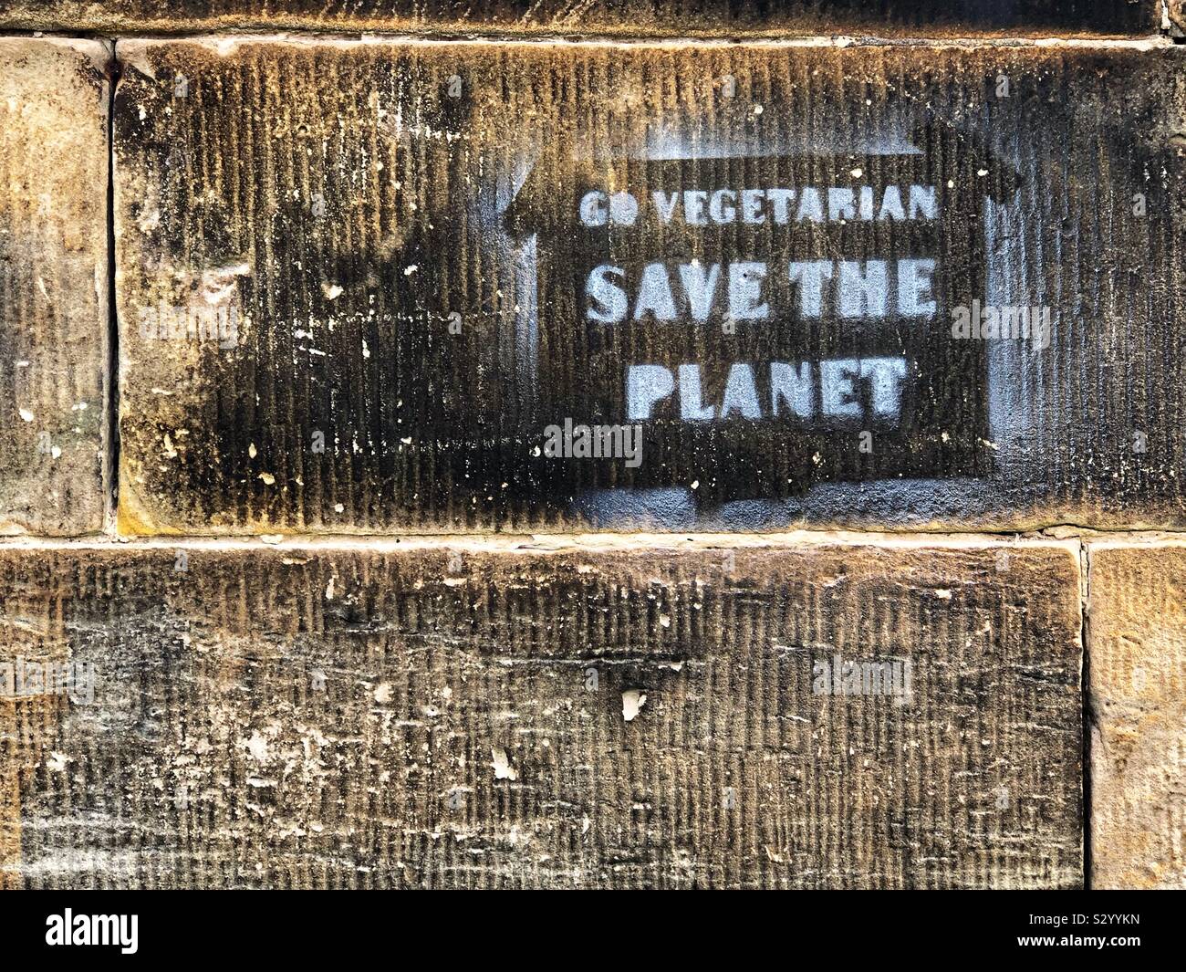 Go vegetarian save the planet graffiti on wall - Smartphone Captured Stock Image