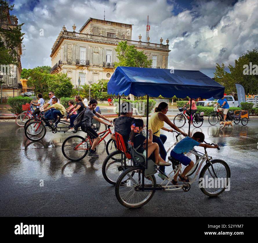 Bike riders fill the avenue on Paseo de Montejo on Sunday mornings when the street is closed to traffic and becomes the Bici Ruta. Stock Photo