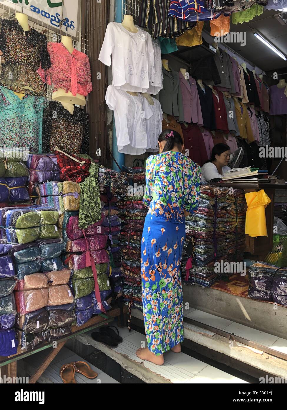 Clothing choices at a local market in Mandalay, Myanmar. Stock Photo