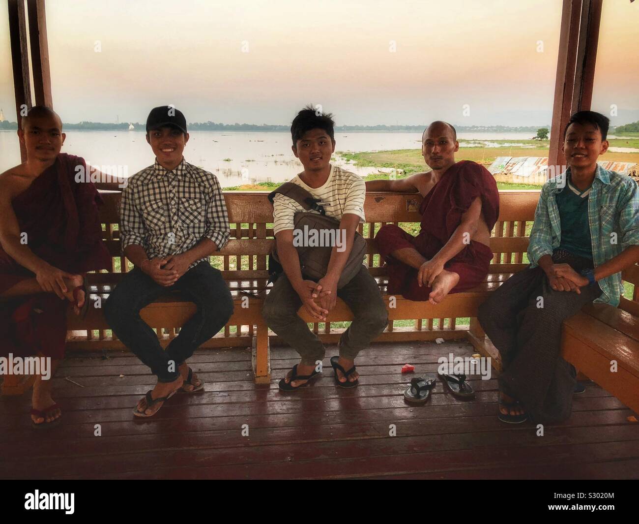 Hanging out on the popular U Bein Bridge in Mandalay, Myanmar. - Smartphone Captured Stock Image