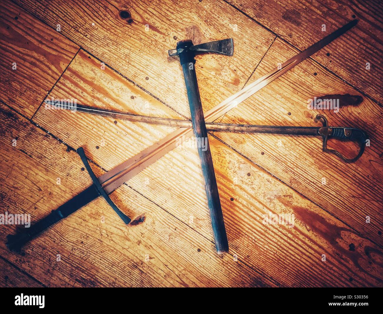 Swords and battle ax arranged on wooden planks - Smartphone Captured Stock Image