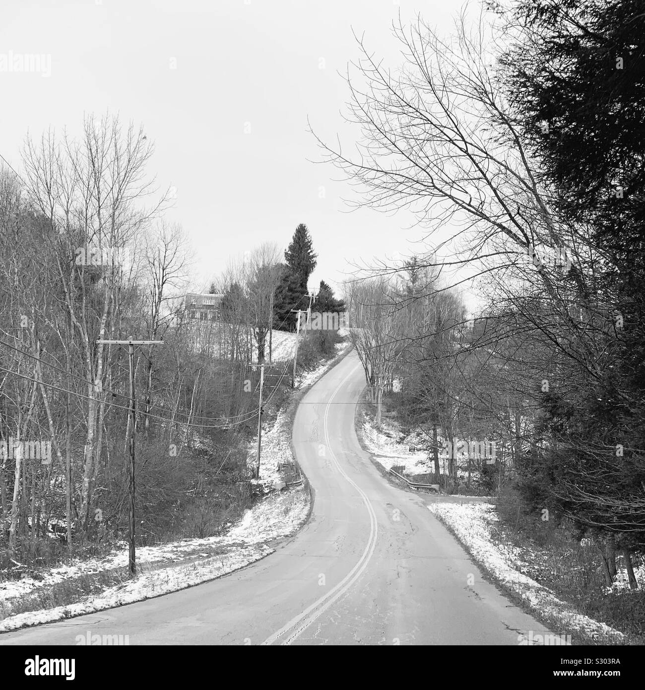 View from the passenger seat of a road winding up a hill, Waitsfield, Vermont, United States - Smartphone Captured Stock Image