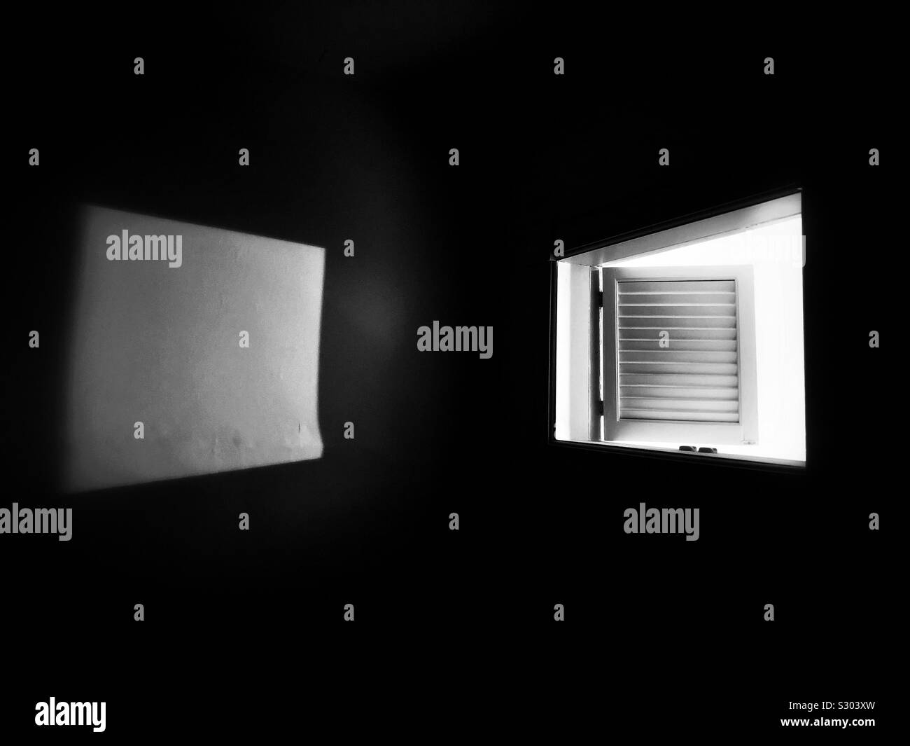 Light entering dark room through louvred hatch door - Smartphone Captured Stock Image