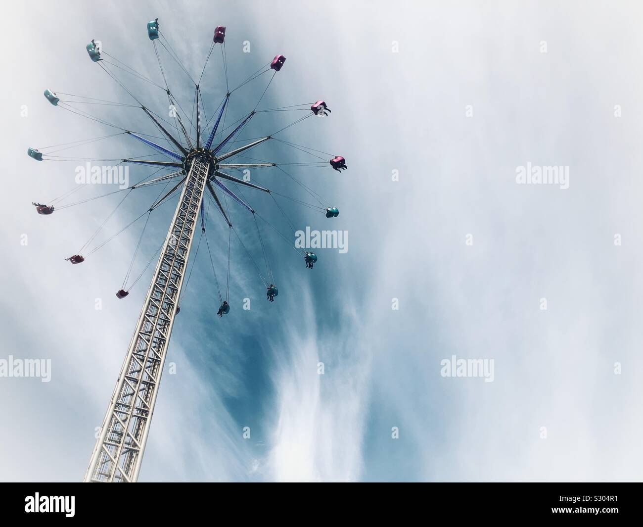 Star flyer spinning big wheel fairground ride at Christmas funfair - Smartphone Captured Stock Image