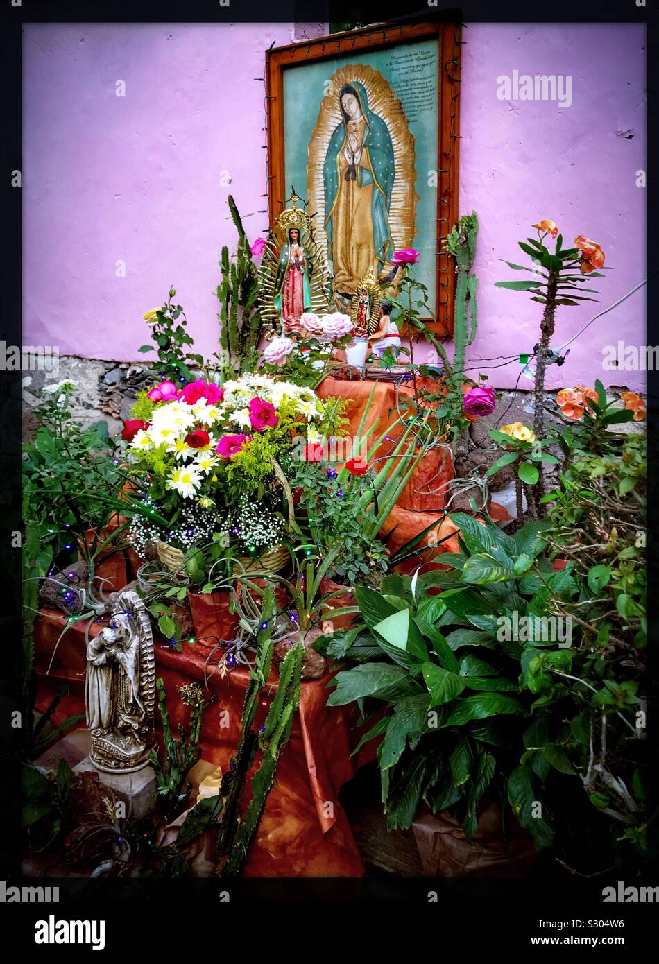 A colorful outdoor altar is set up outside a home in San Antonio Tlayacapan to honor the Virgin of Guadalupe on Guadalupe Day. Stock Photo