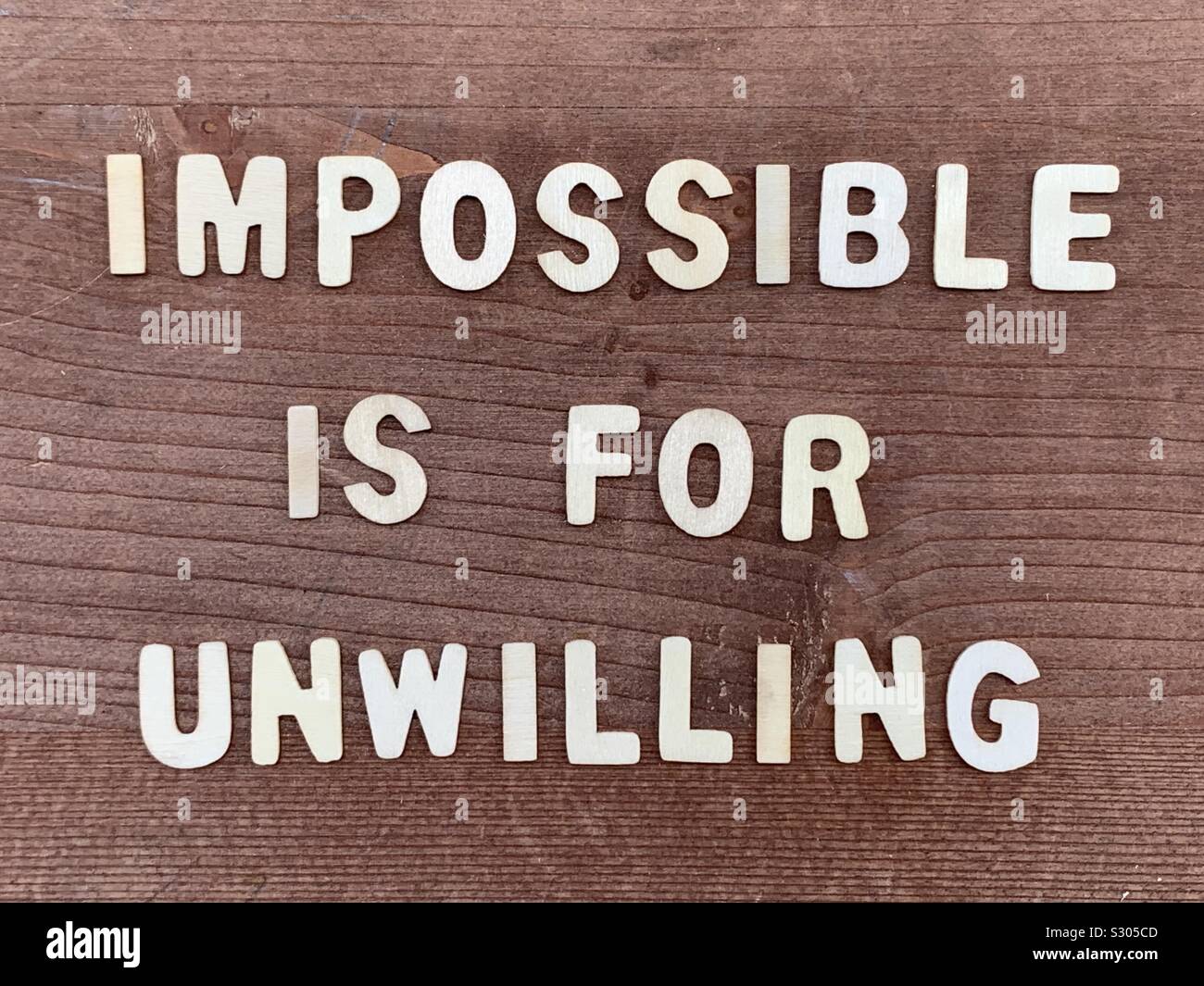 Impossible is unwilling, motivational quote composed with wooden letters - Smartphone Captured Stock Image