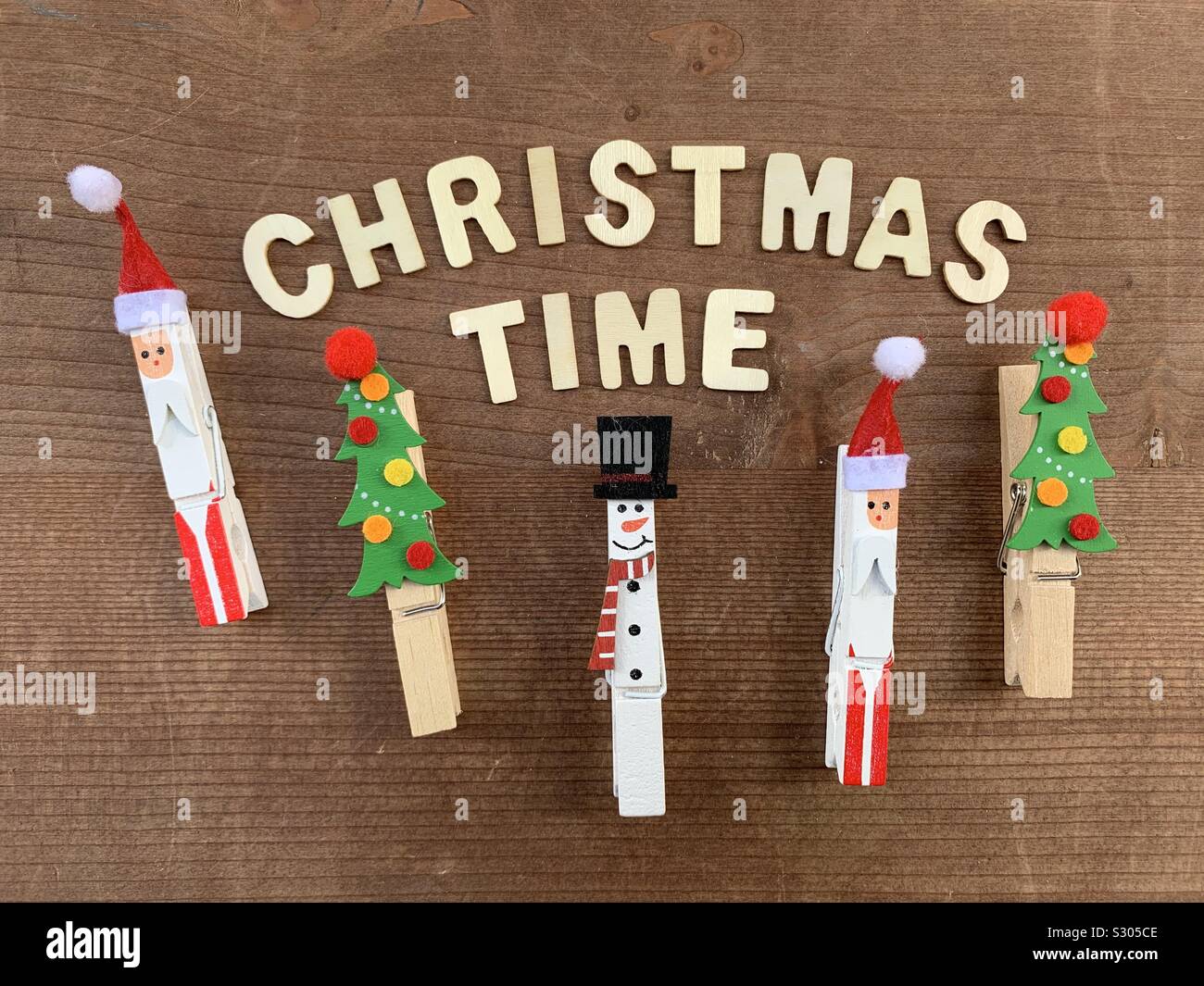 Christmas time composed with festive ornaments and wooden letters - Smartphone Captured Stock Image