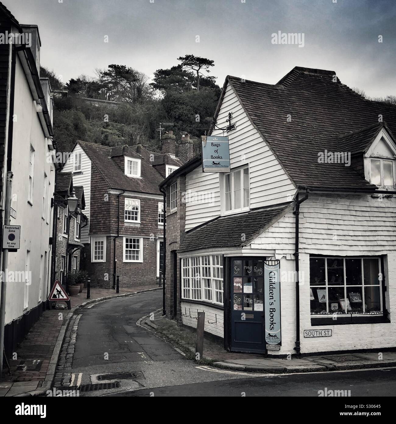 Street scene in historic Lewes in East Sussex, England. On the corner of South Street and Chapel Hill is Bags of Books children’s bookshop. - Smartphone Captured Stock Image