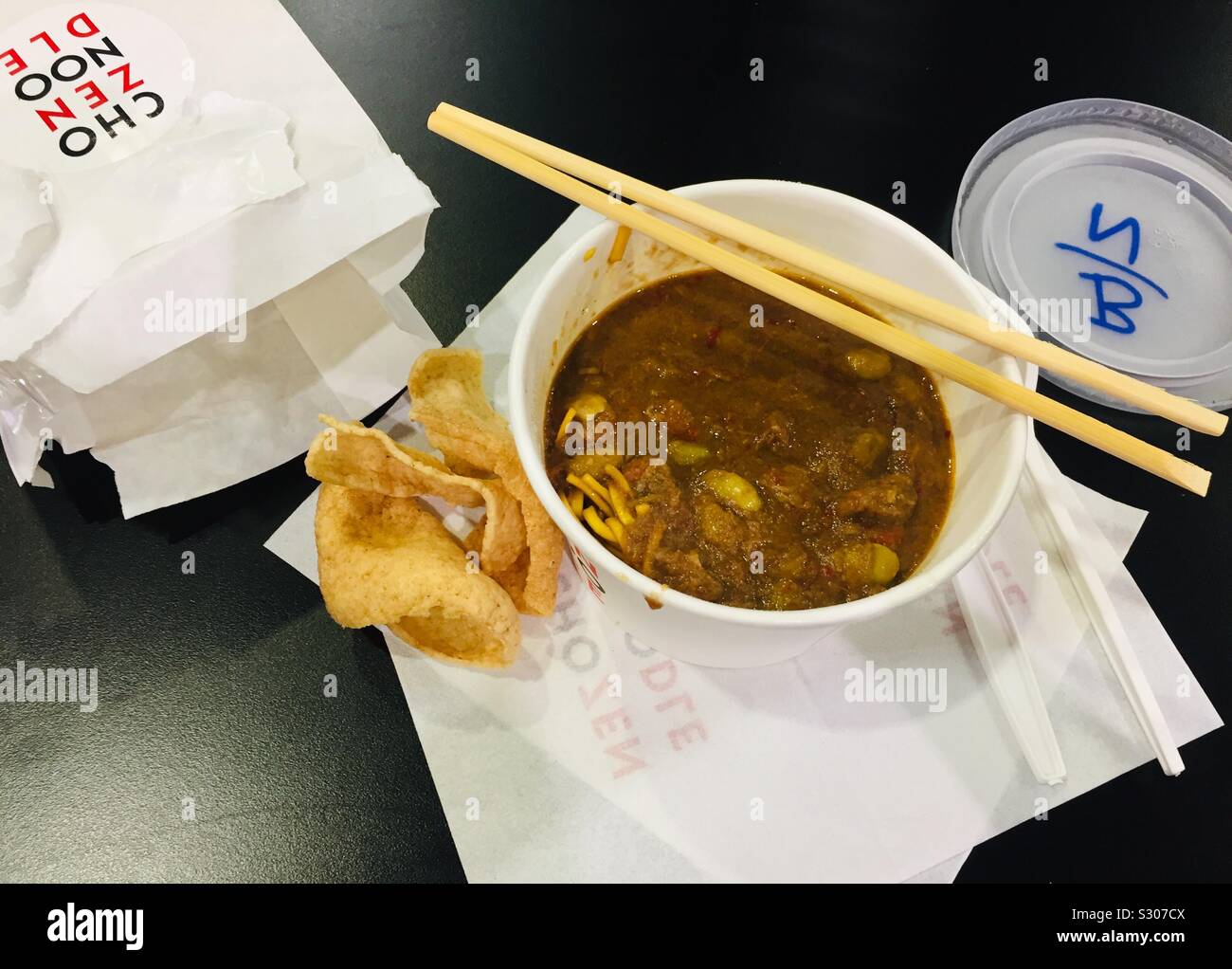 Thai beef noodles. Hot take away food. Chop sticks over noodles. London, Excel exhibition centre - Smartphone Captured Stock Image