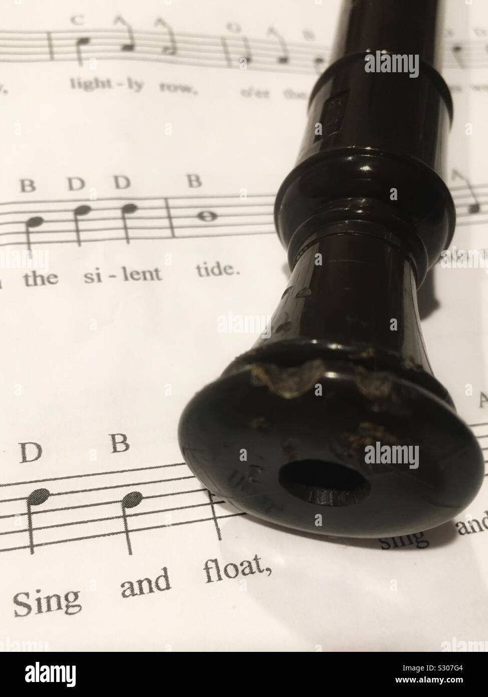 Sing and Float Recorder on Sheet Music Stock Photo