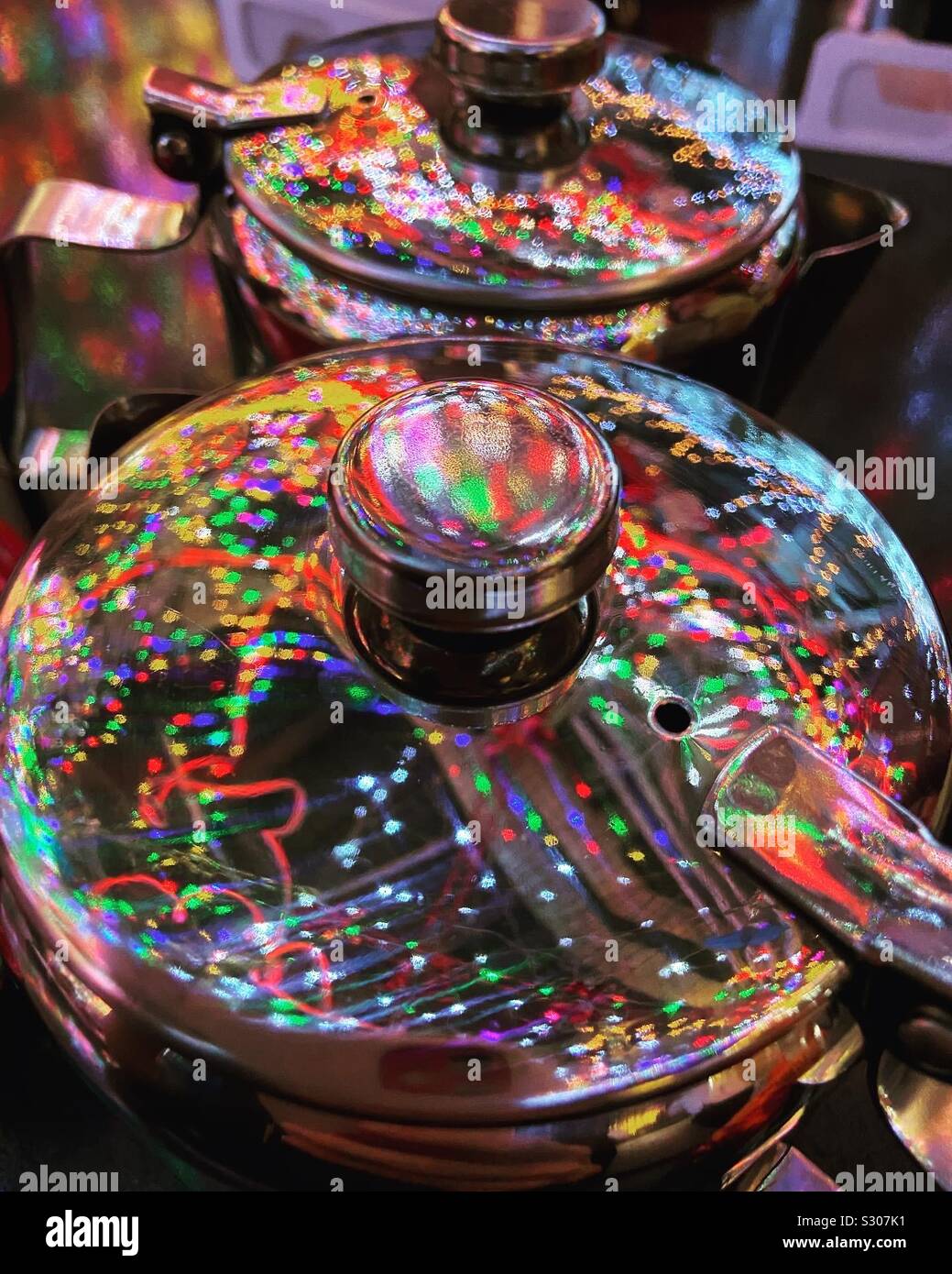 Lights reflected off metal tea pots - Smartphone Captured Stock Image