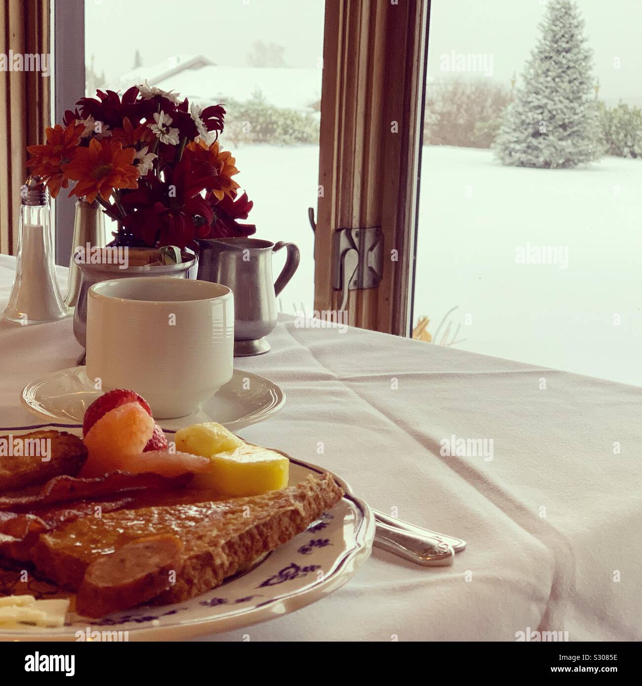 French toast on the breakfast table, overlooking the snowy landscape outside, Dining Room, Trapp Family Lodge, Stowe, Vermont, United States - Smartphone Captured Stock Image