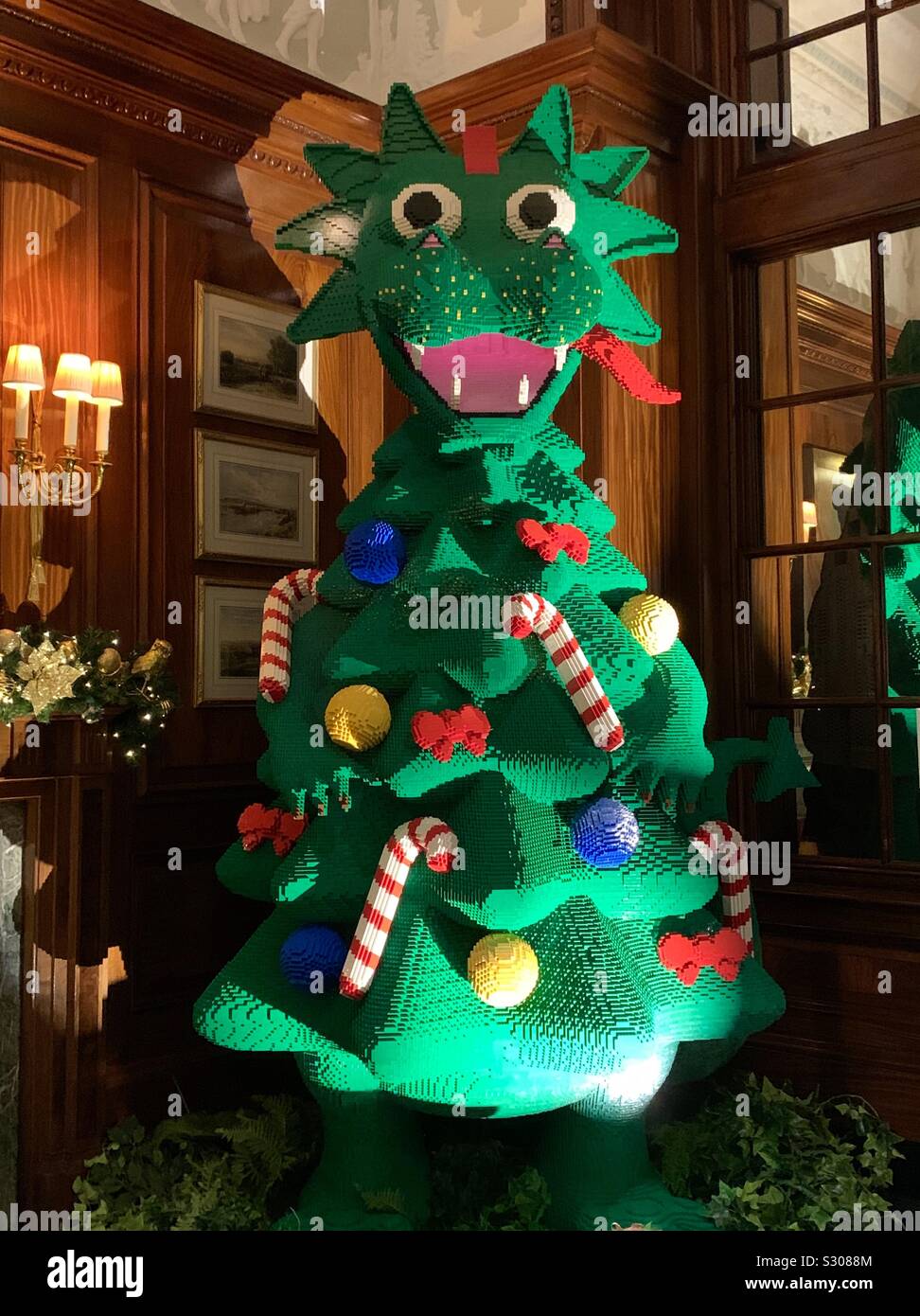 A very happy monster Christmas tree made of Lego, in a corner of the foyer  in The Savoy Hotel, London Stock Photo - Alamy