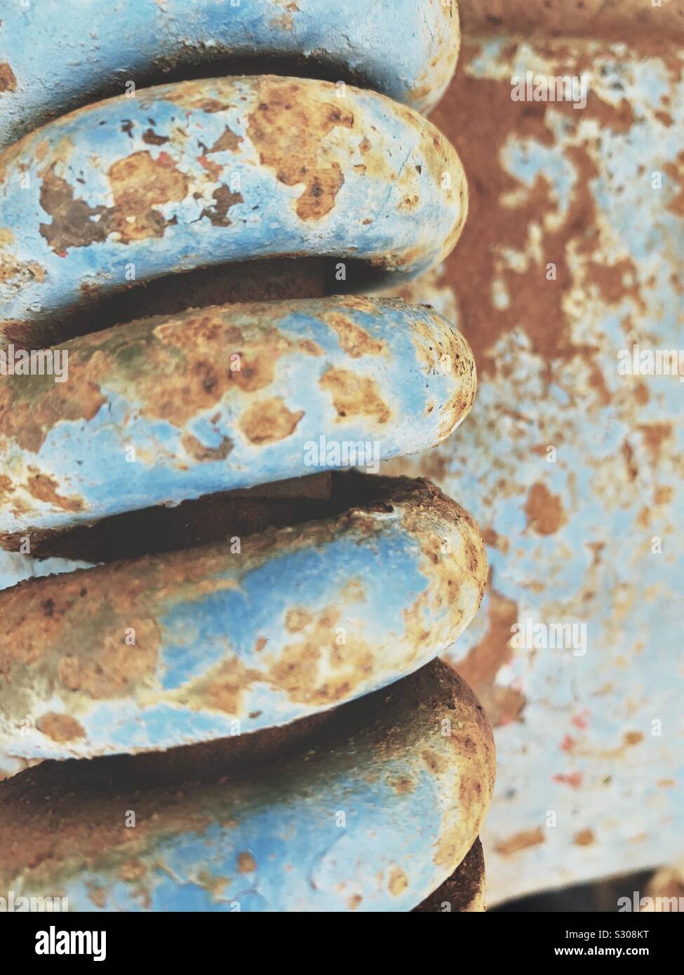 Rusted metal coil with peeling paint Stock Photo