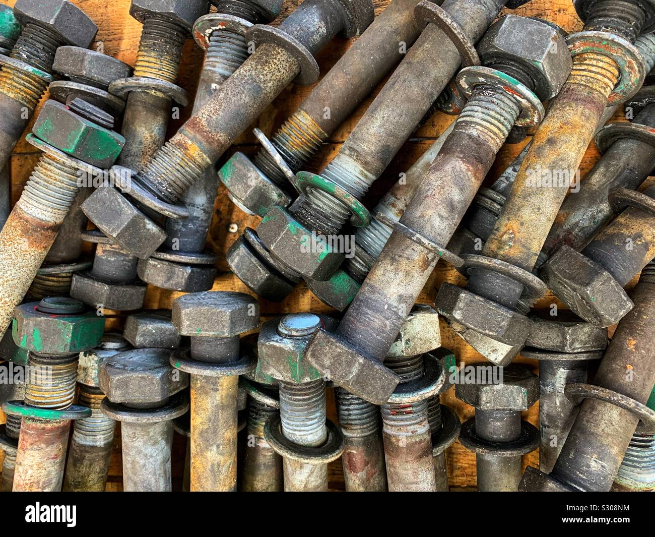 A flat lay collection of large bolts washers and nuts seen from above. Stock Photo