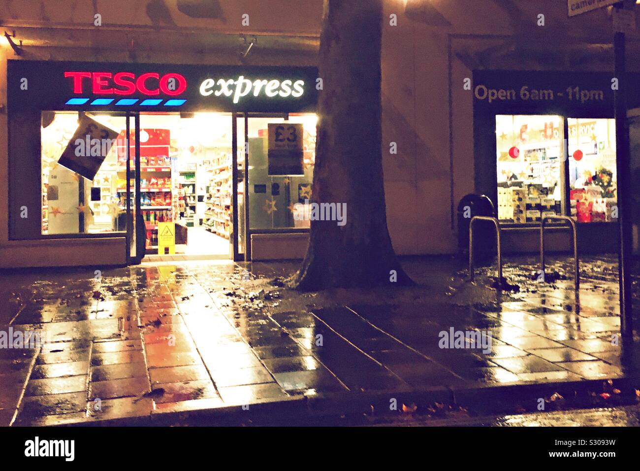 A Tesco Express store on a rainy night Stock Photo