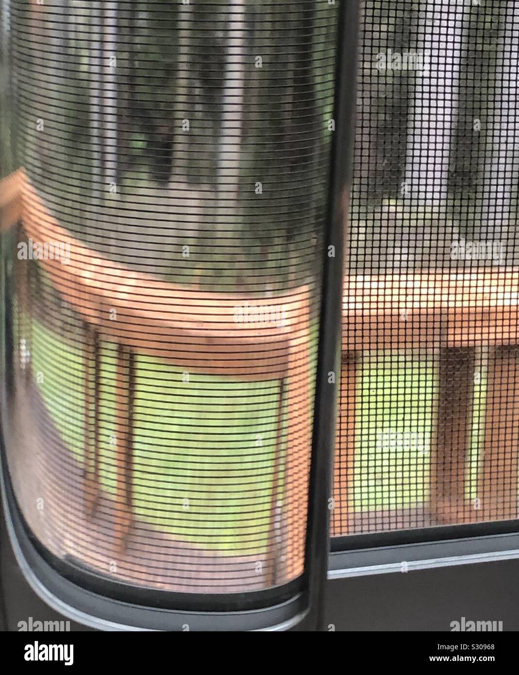 View through a tube of water and window screen Stock Photo