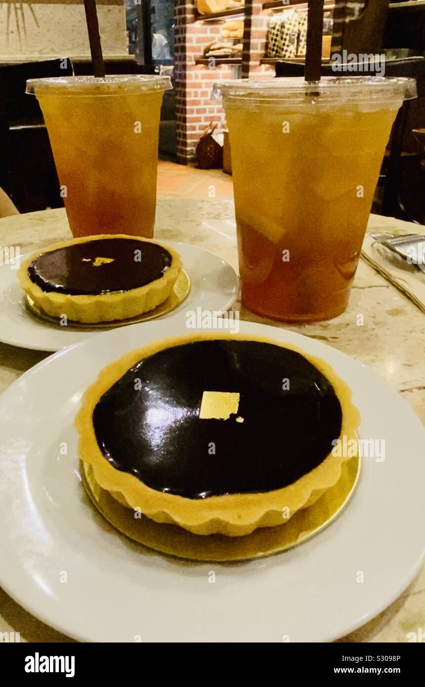 Chocolate tarts and drinks on café table Stock Photo