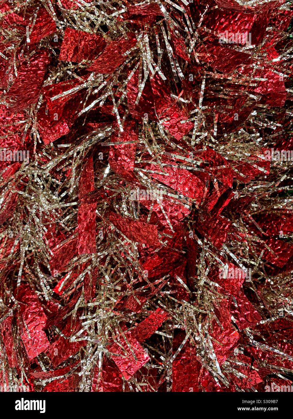 Red and gold holiday tinsel decoration - Smartphone Captured Stock Image