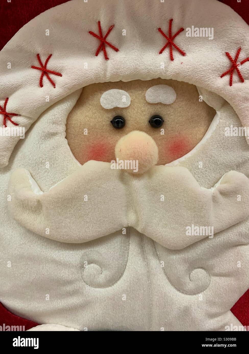 Crafty fabric Santa Claus face made out of felt material Stock Photo
