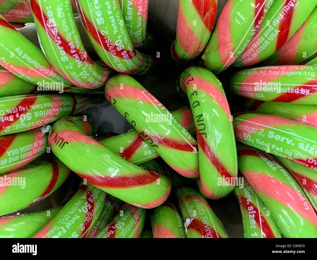Many green festive candy canes with red and pink stripes - Smartphone Captured Stock Image