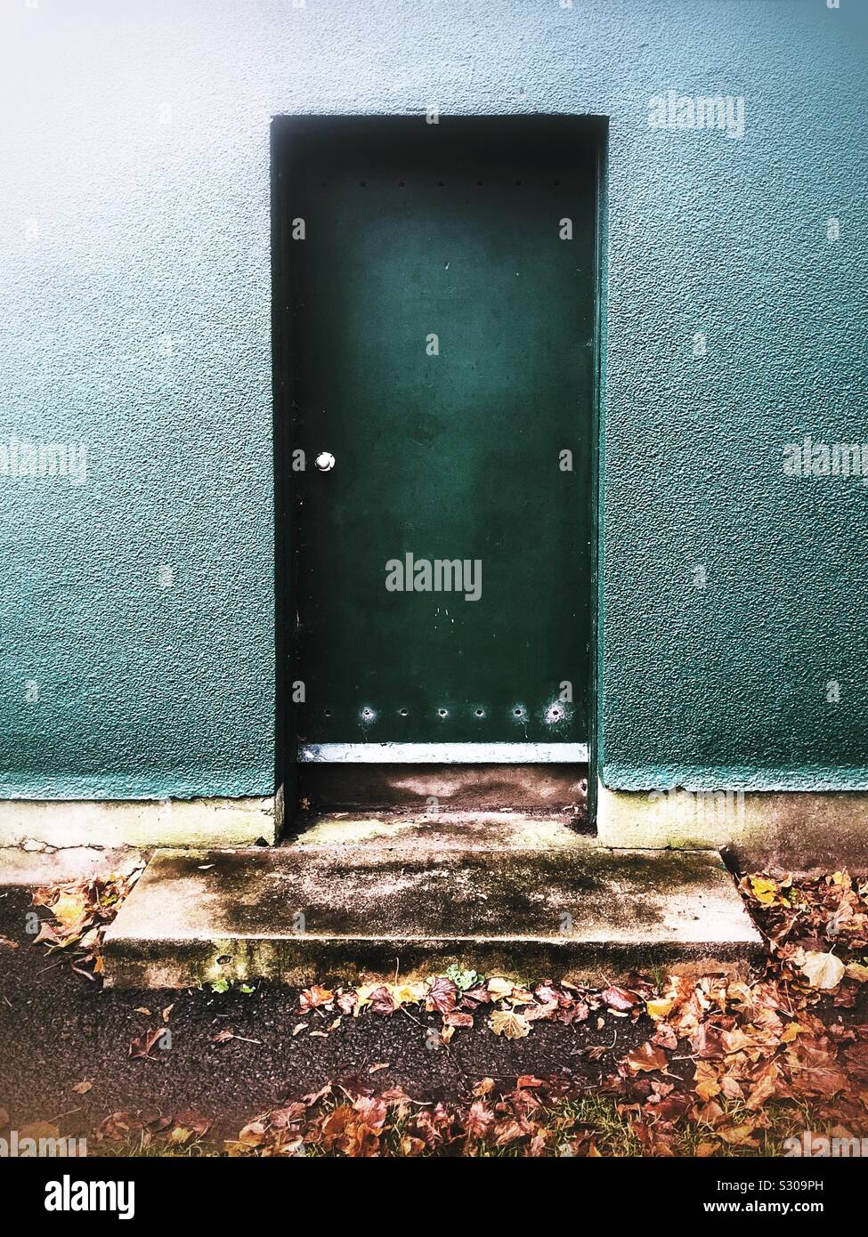External green door on outbuilding - Smartphone Captured Stock Image