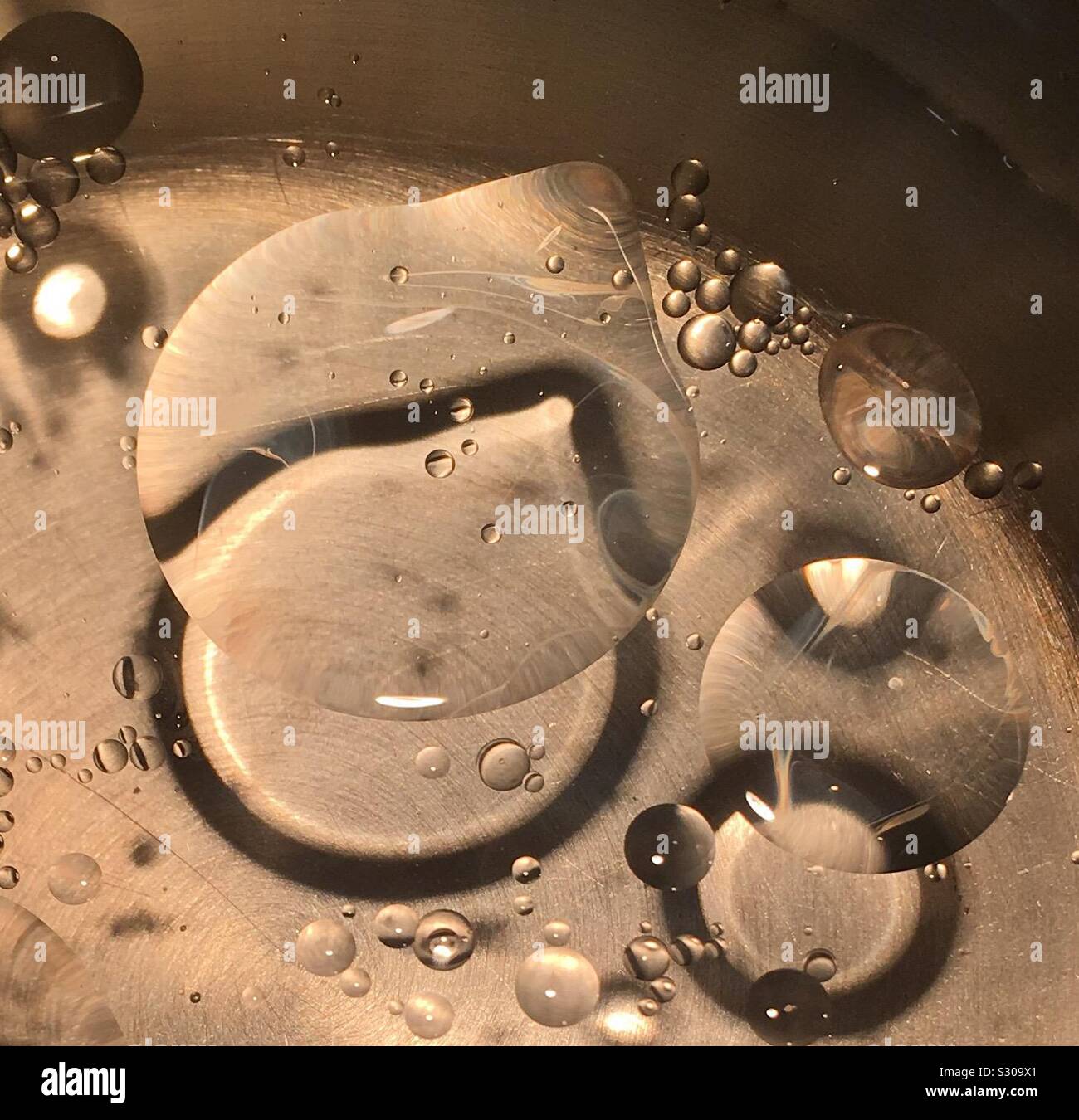 Oil bubbles in boiling water Stock Photo