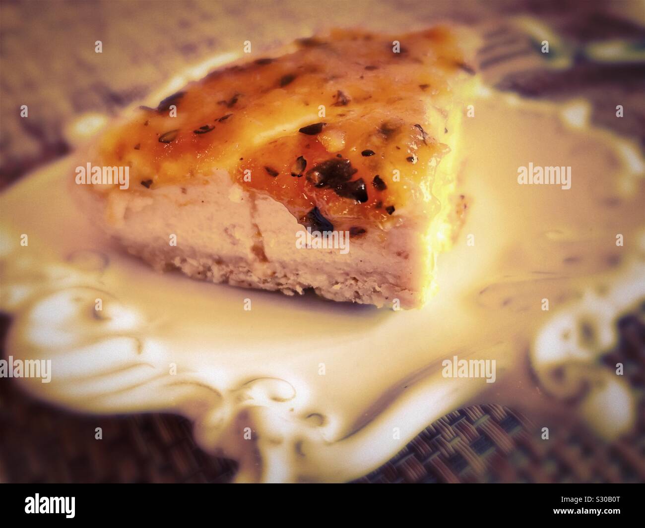 A passion fruit glaze tops a creamy cheesecake over a shortbread crust. Stock Photo