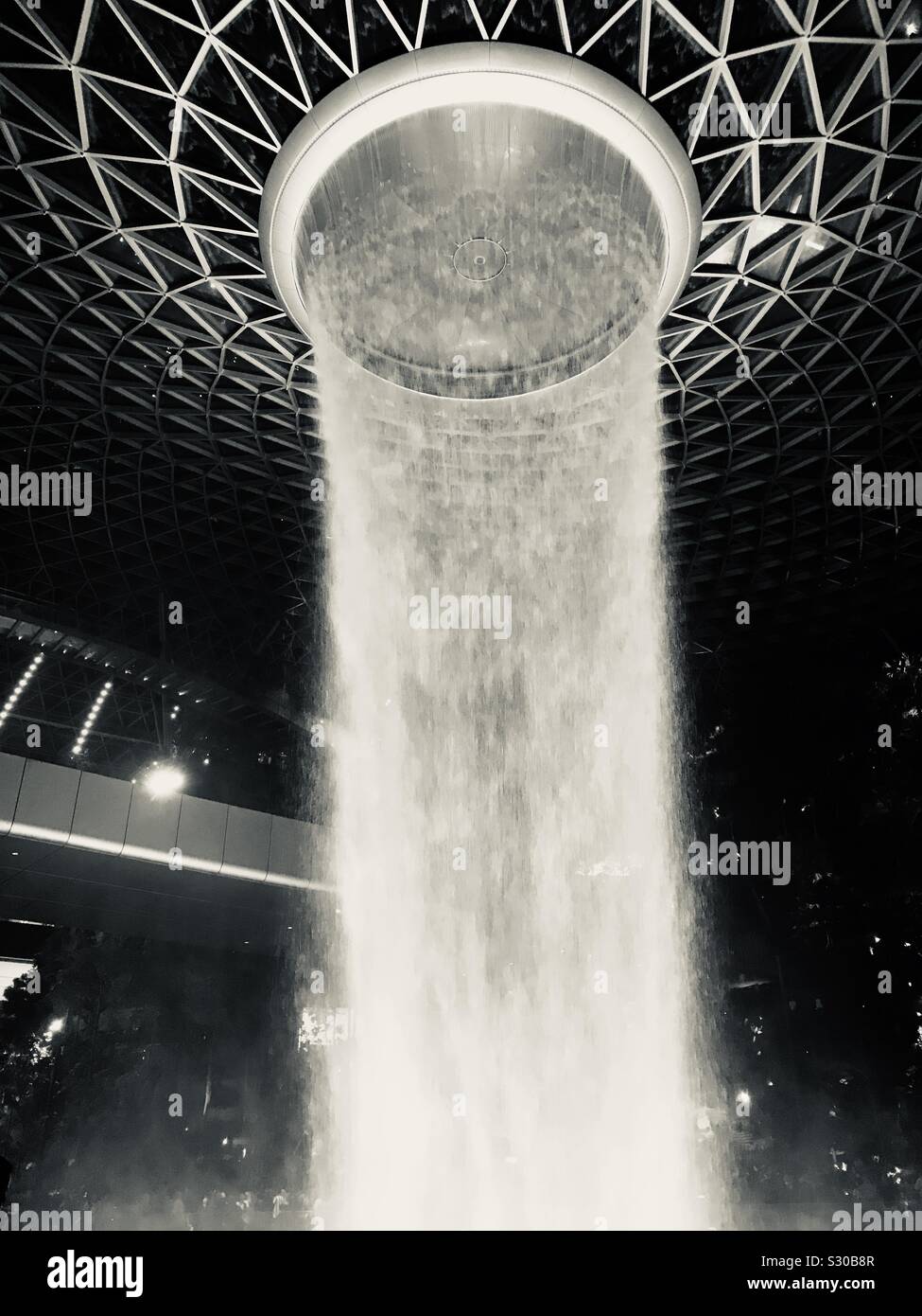 Silver colour- HSBC rain Vortex in Singapore Jewel Changi Airport- water gushing from 7 storey height Stock Photo