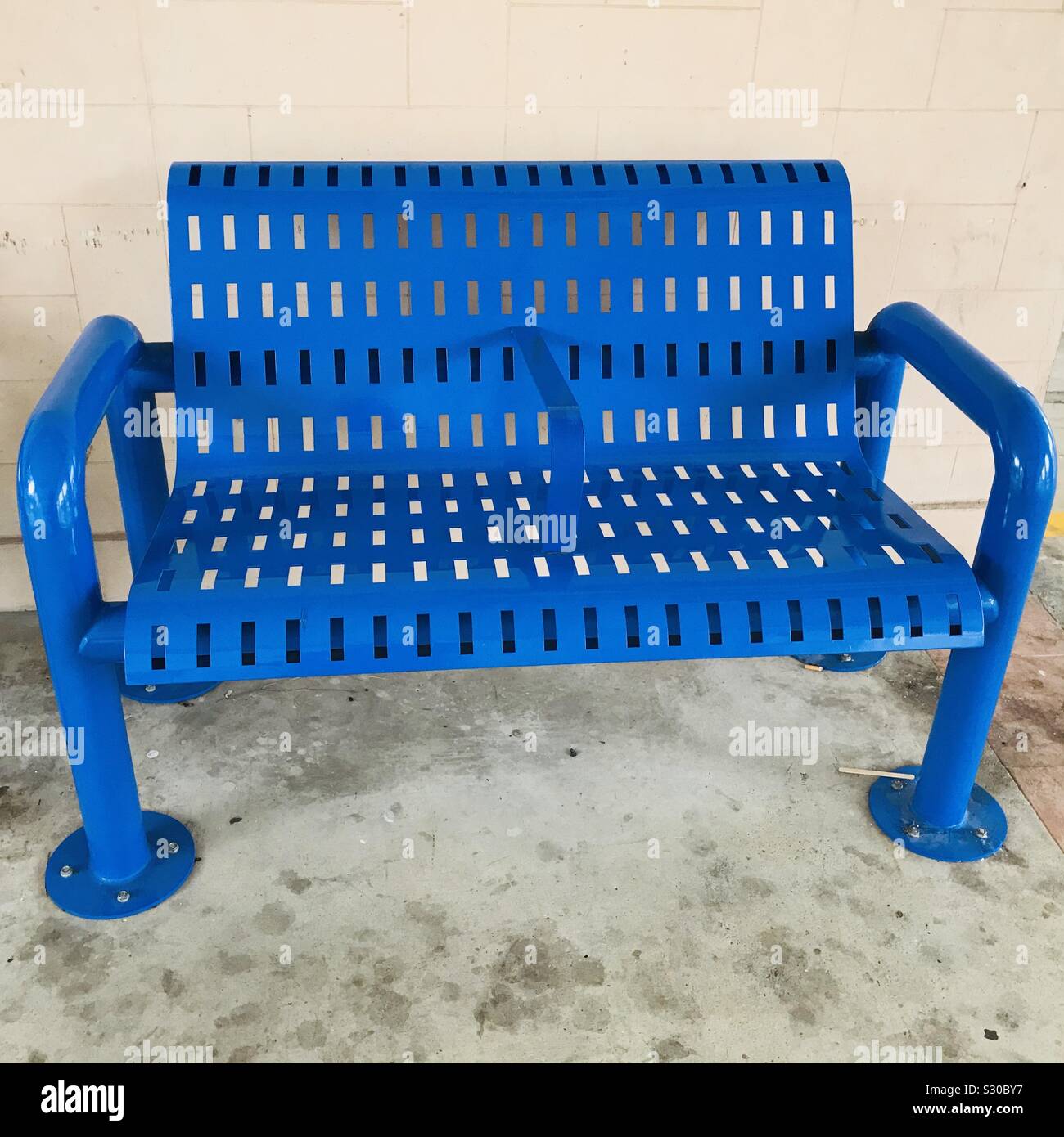 Metal bench Ina public place with fluorescent blue colour, resting area void deck Stock Photo