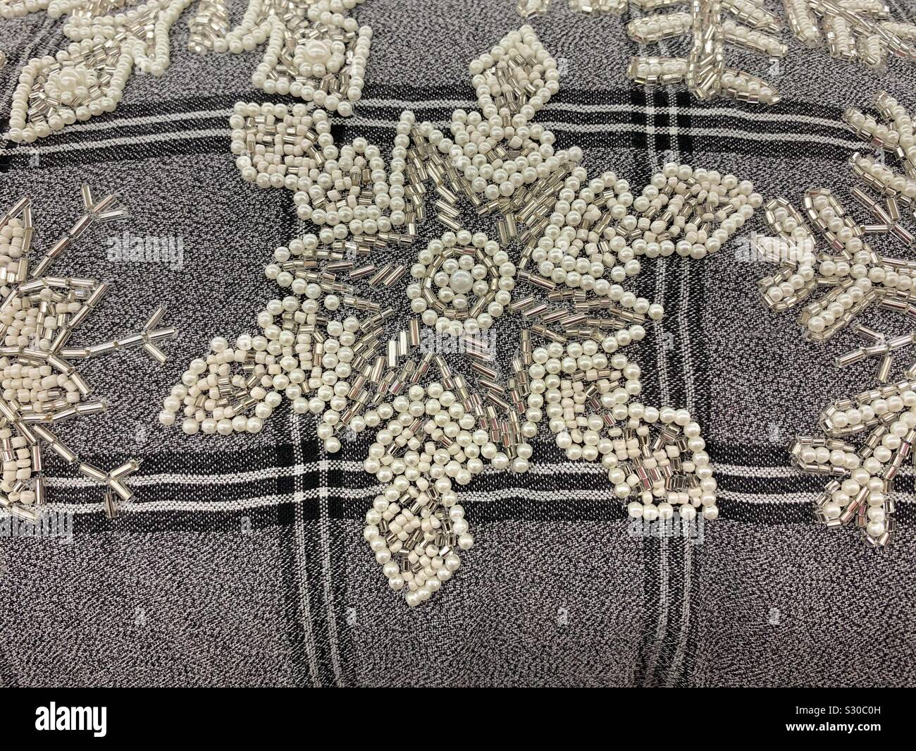 Snowflake star embroidery with silver and white beads - Smartphone Captured Stock Image