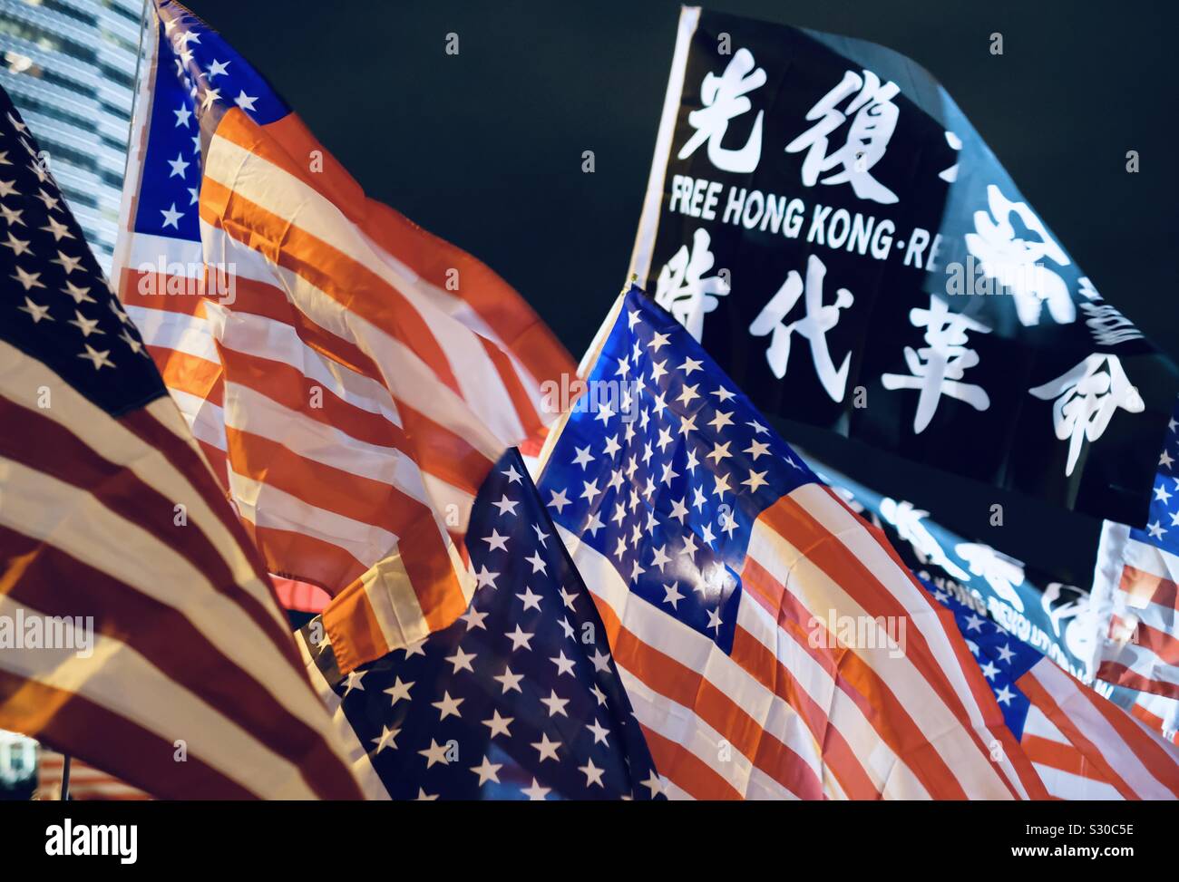 Hongkong - November 28, 2019: Hongkonger thanking USA by holding American flag on demonstration in downtown HongKong Stock Photo