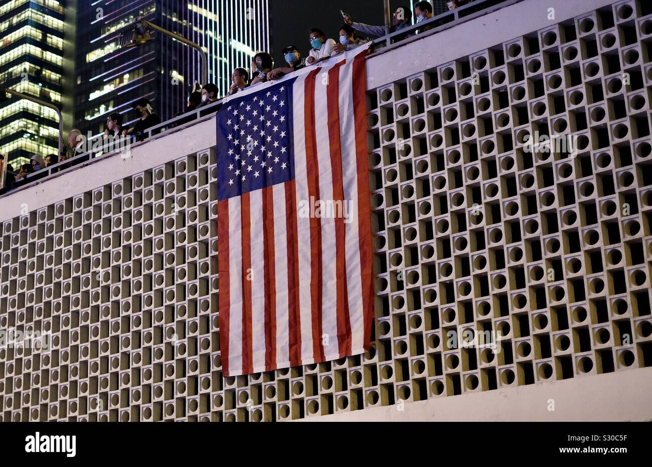 Hongkong - November 28, 2019: Hongkonger thanking USA by holding American flag on demonstration in downtown HongKong Stock Photo