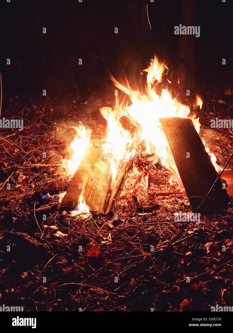 Bonfire glows after dark - Smartphone Captured Stock Image