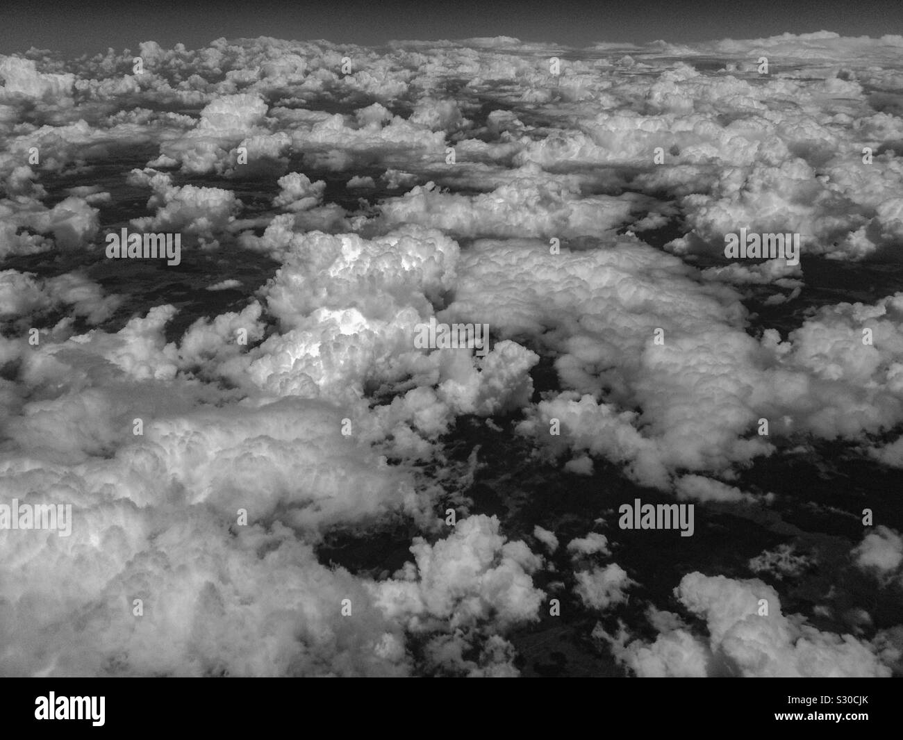 Clouds over the Great Plains of the USA. Monochrome. Flyover state. Stock Photo
