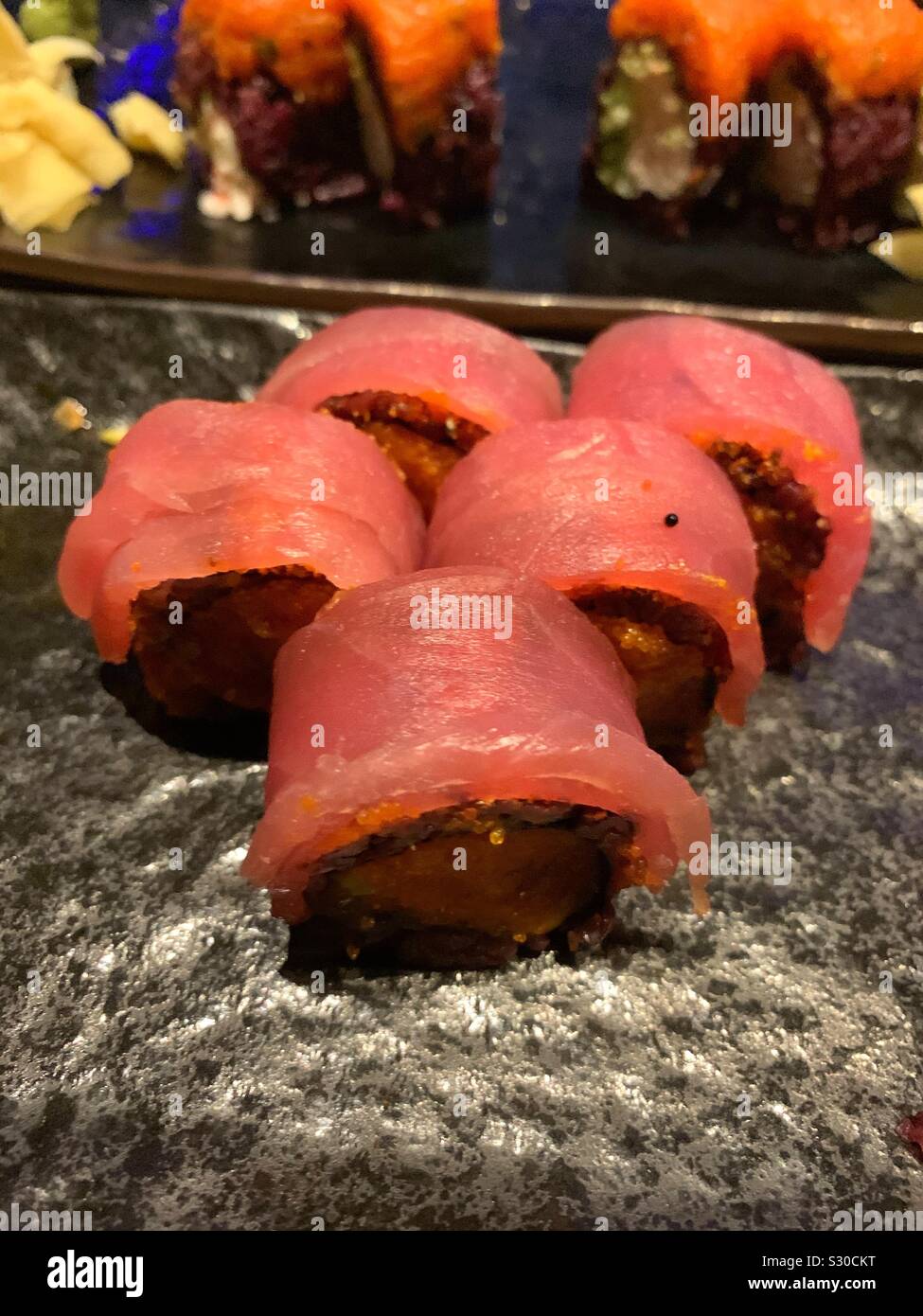 Delicious sushi rolls covered with fresh tuna fish - Smartphone Captured Stock Image