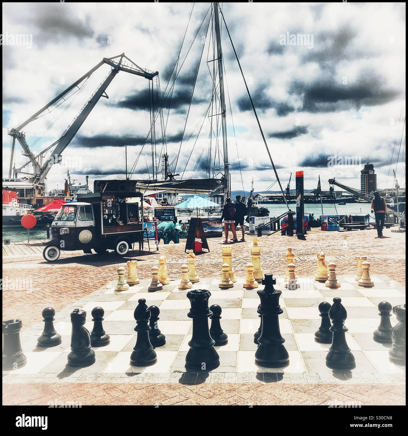 Food truck and giant chessboard, V&A Waterfront, Cape Town, South Africa. - Smartphone Captured Stock Image