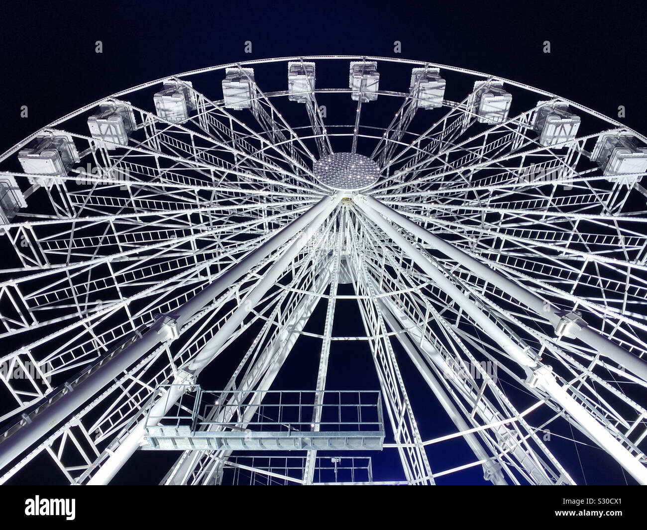 Giant Ferris wheel illuminated at night - Smartphone Captured Stock Image