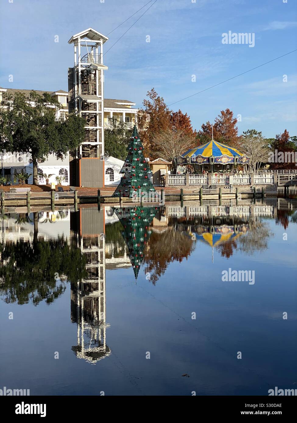 Reflections on a lake of water of zip line and buildings - Smartphone Captured Stock Image