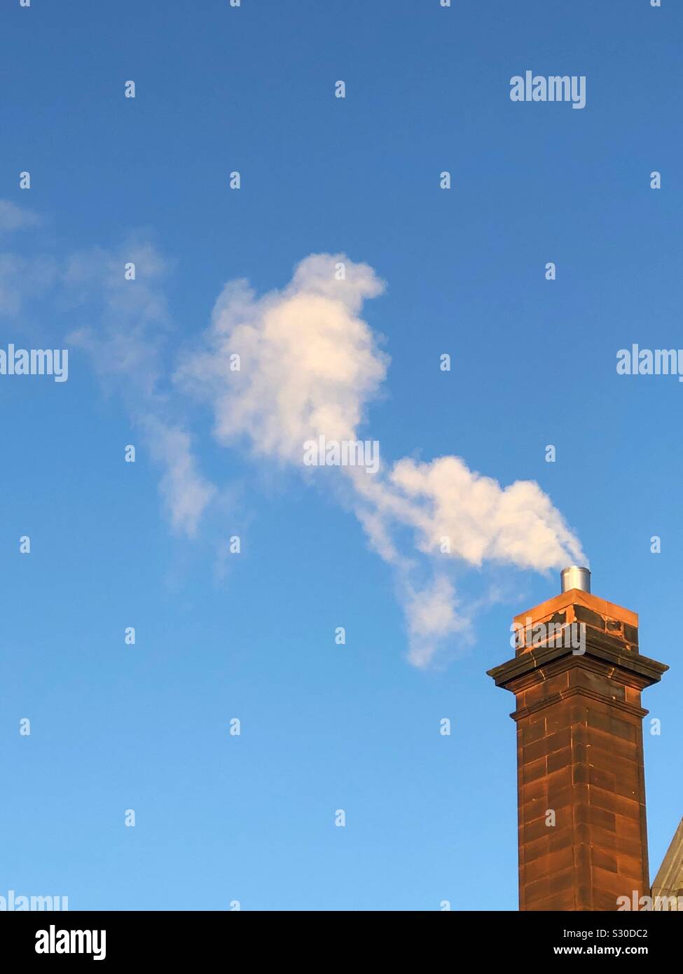 Smoke from brick chimney - Smartphone Captured Stock Image