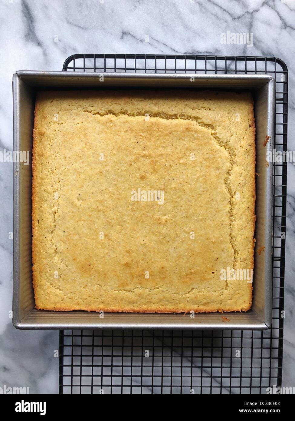 Homemade cornbread resting in a cooling rack - Smartphone Captured Stock Image