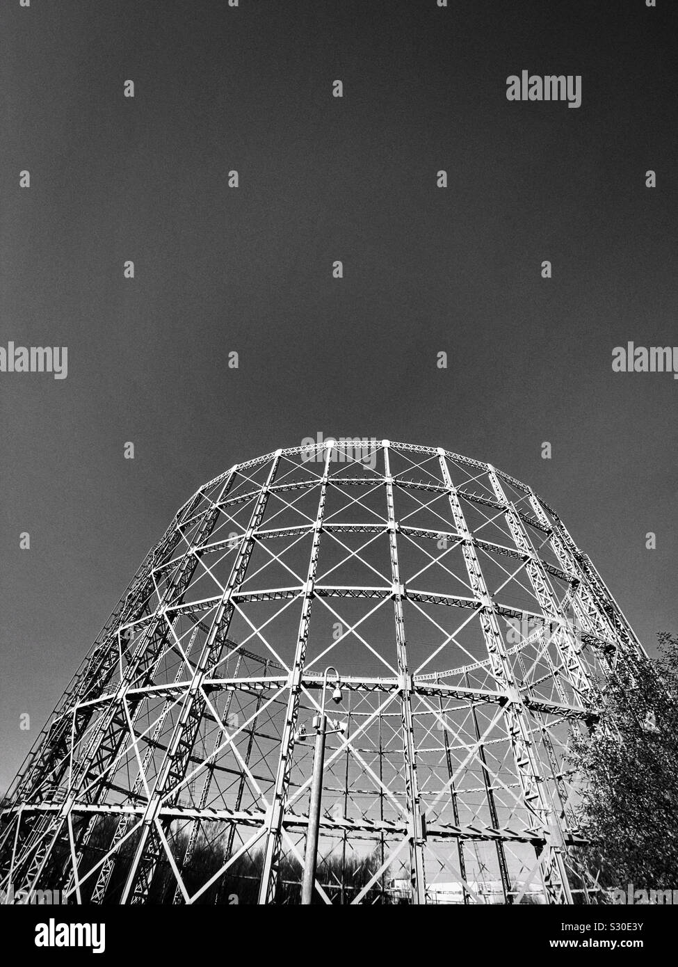 Steel framework of gasometer against a clear sky Stock Photo
