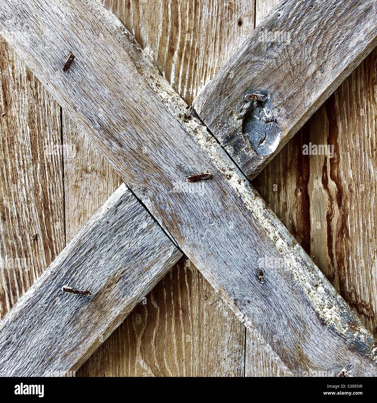 Oak “X” bracing inside old door. - Smartphone Captured Stock Image