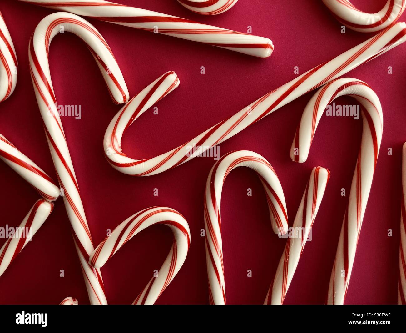 Candy canes on a red background - Smartphone Captured Stock Image