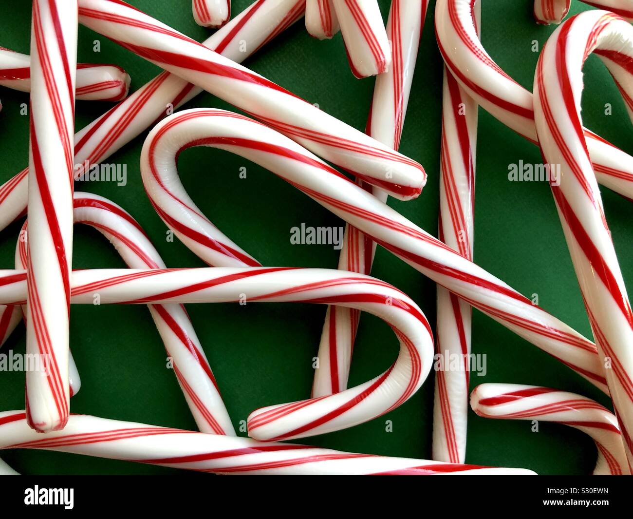 Candy canes on a green background - Smartphone Captured Stock Image