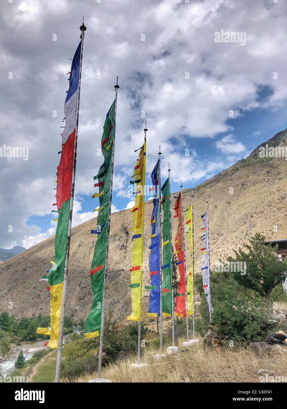 Colourful prayer flags fluttering in the wind in Bhutan. - Smartphone Captured Stock Image
