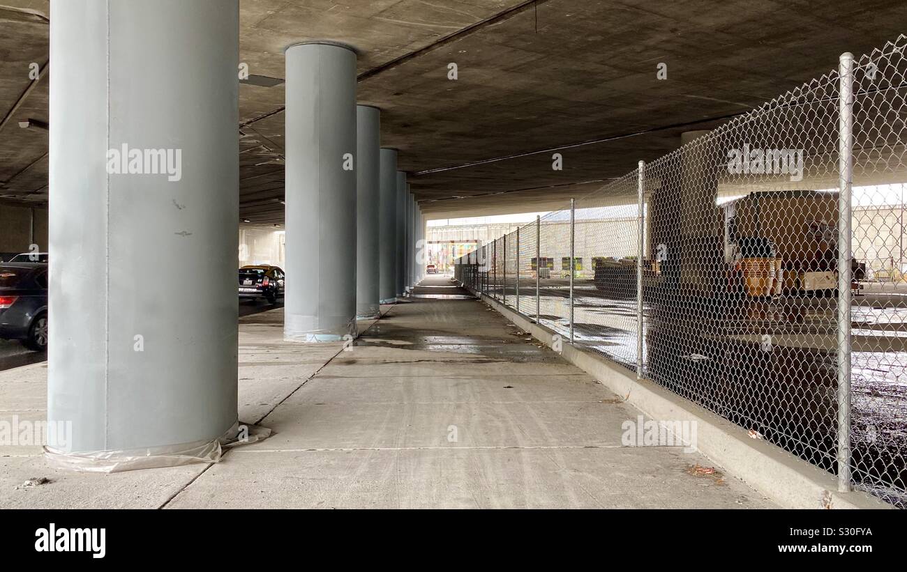 LOS ANGELES, CA, NOV 2019: freshly painted grey concrete pillars supporting an underpass in Burbank - Smartphone Captured Stock Image