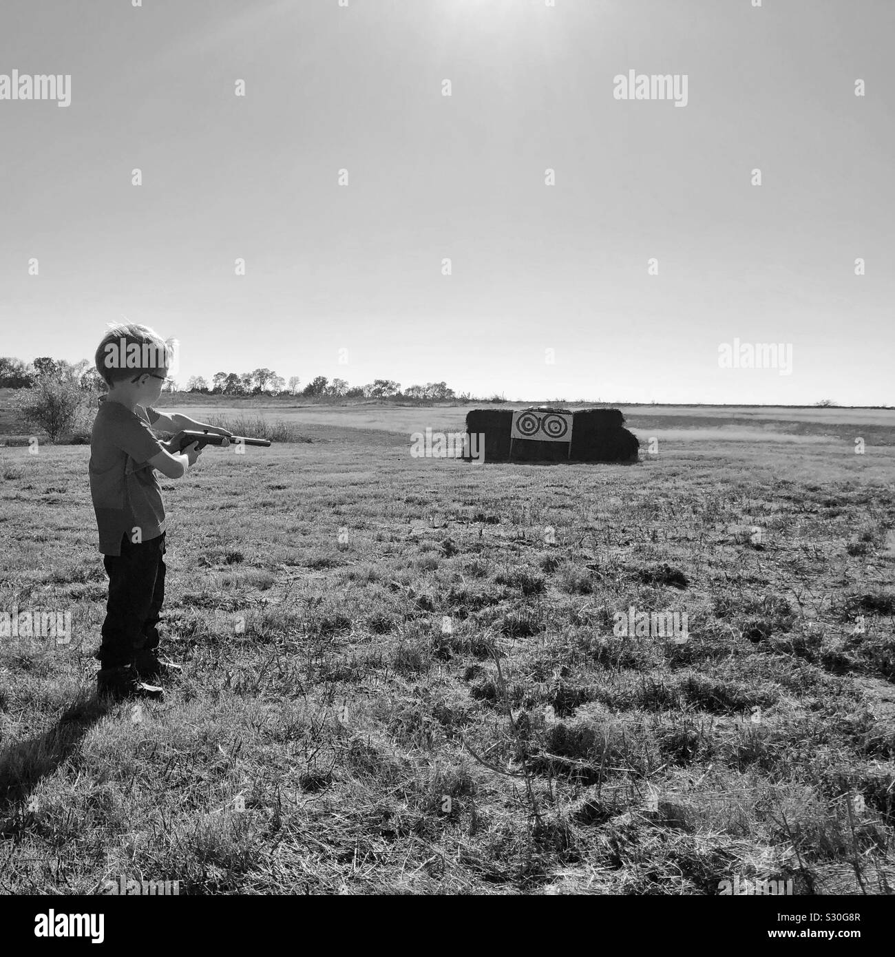 Kid with gun in country Stock Photo Alamy